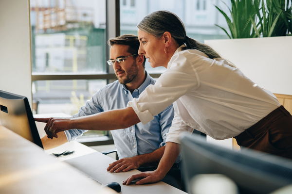 IT support manager discussing salary data with colleague