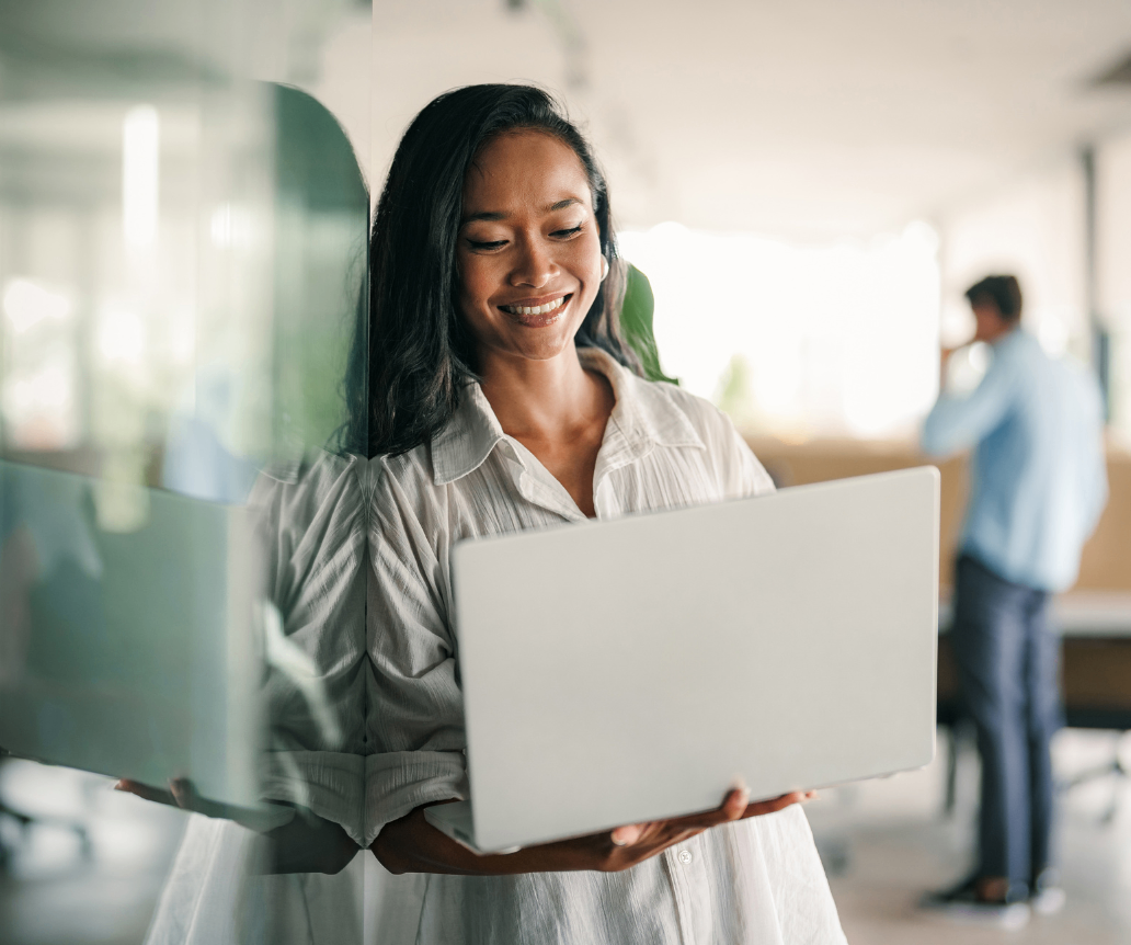 Data professional looking at 2026 salary data on laptop in office