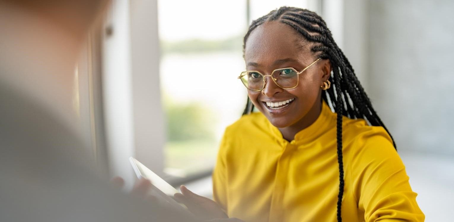 HR Assistant wearing a yellow shirt having a discussion