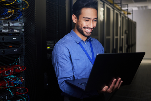 IT infrastructure professional looking at salary data in server room