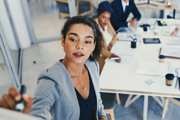 Product manager discussing 2026 salary data on flipboard with team