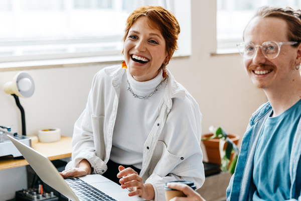 Two social media managers discussing 2026 salary data