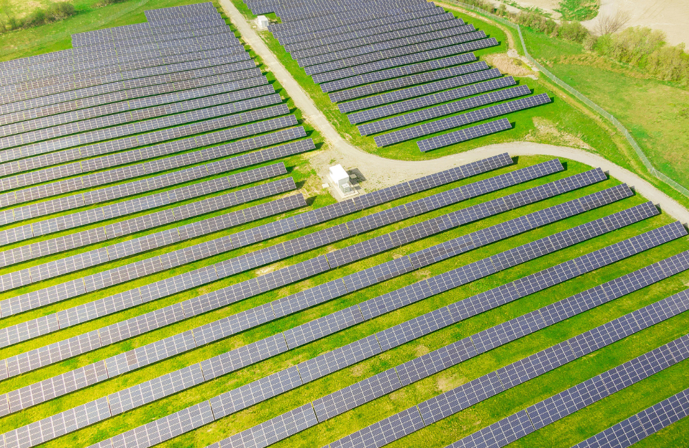 Utility-scale solar energy farm with extensive photovoltaic panel arrays generating renewable electricity