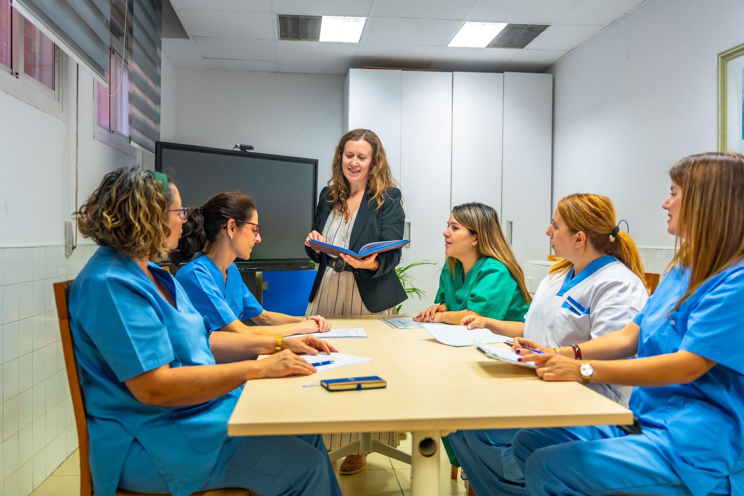 Team of health workers sitting meeting room