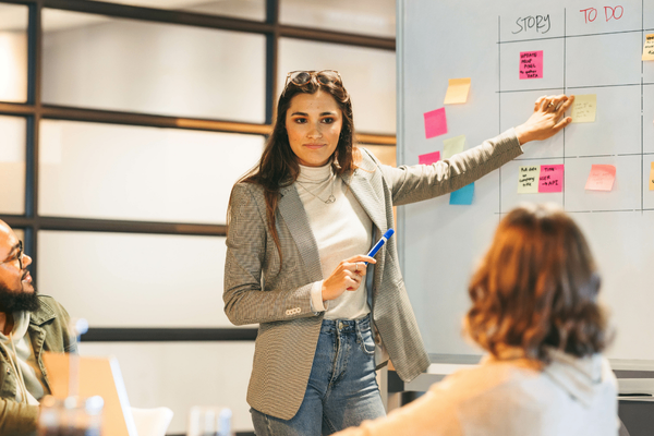 Project manager discussing 2026 salary data in team meeting