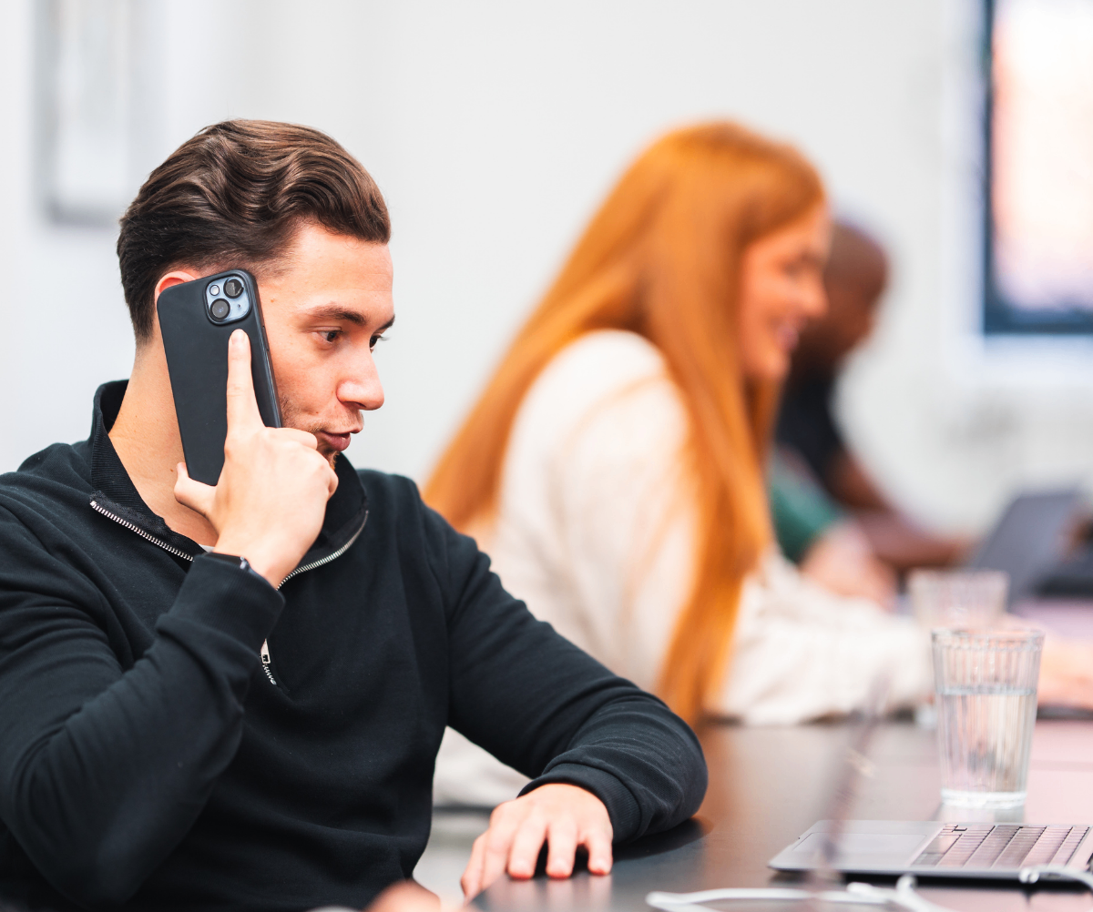 Recruiter discussing recruitment costs on phone