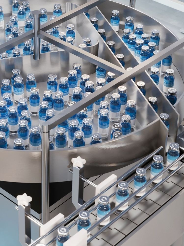 blue liquid in medical bottles on manufacturing line