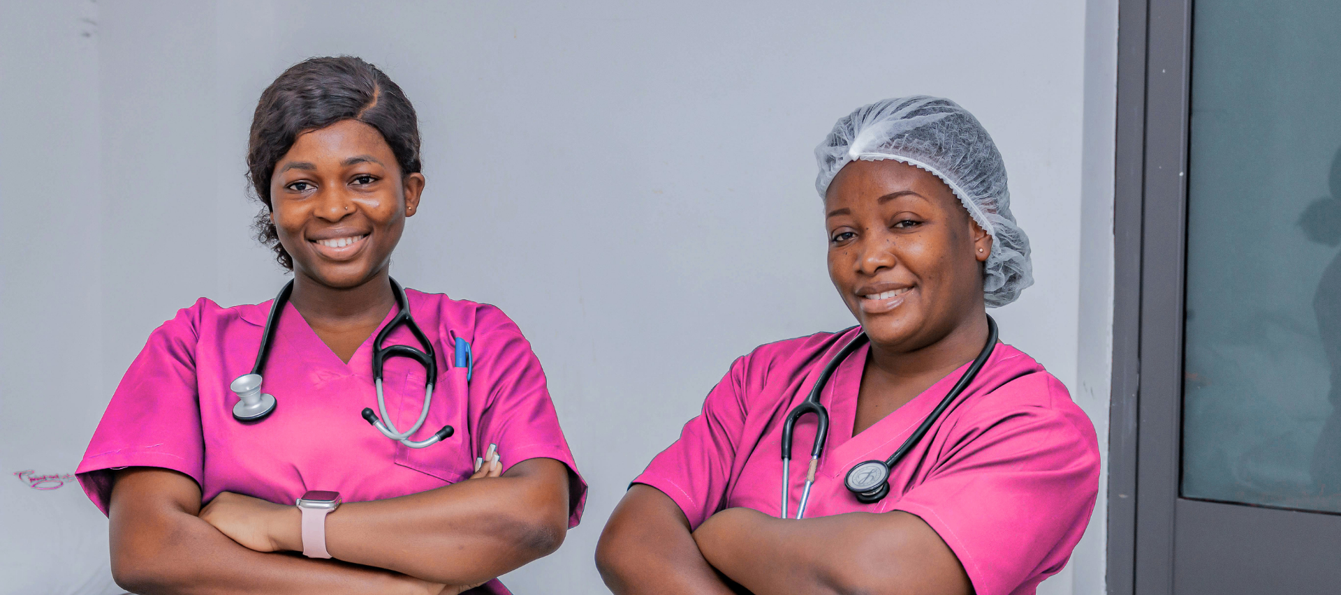 Two women nurses wearing pink scrubs