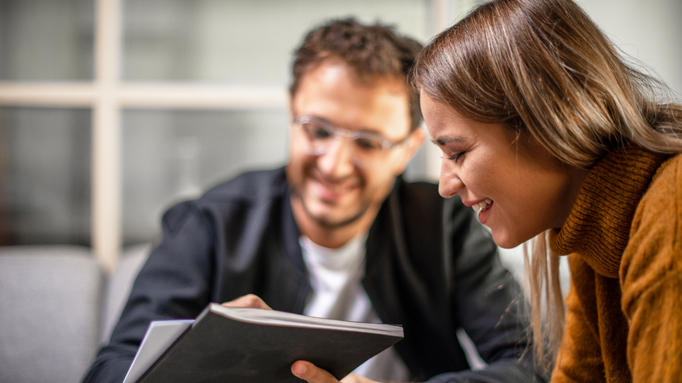 Man and women smiling in office
