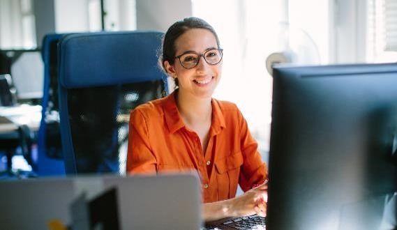 Person smiling using a computer