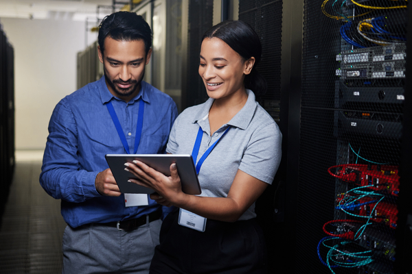 IT networking team looking at 2026 salary data on tablet