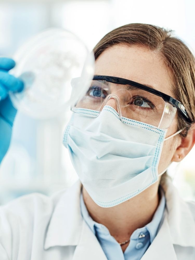 woman holding petri dish