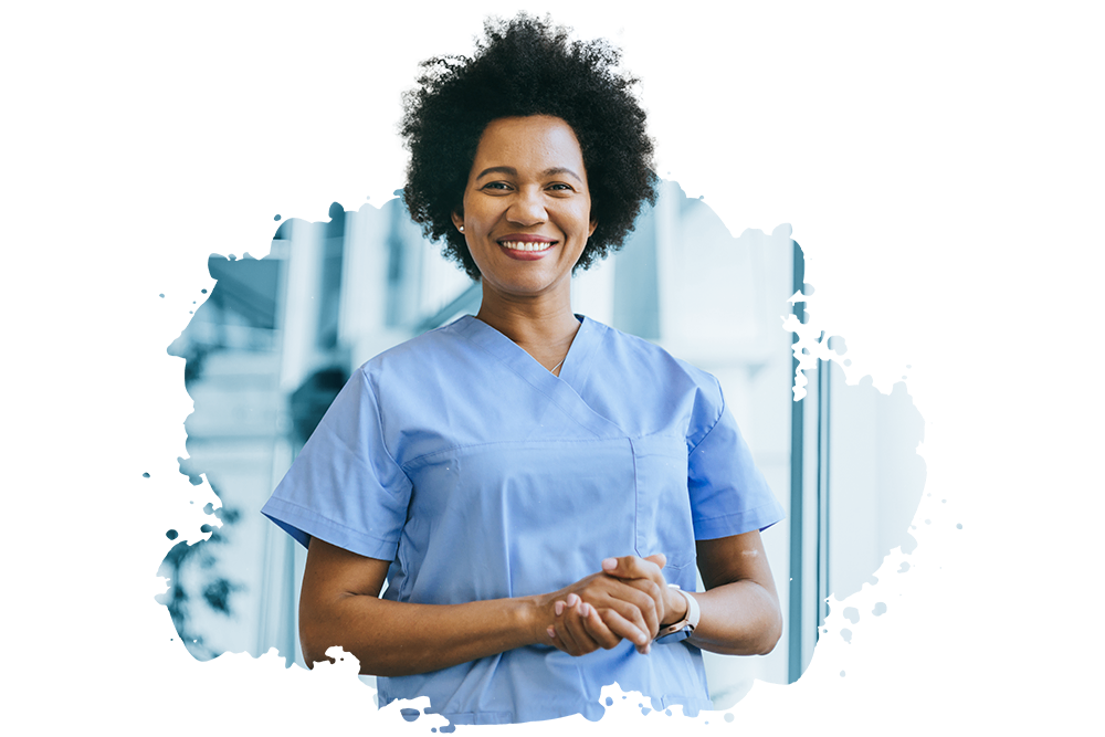 Smiling healthcare professional in light blue scrubs standing in a modern medical facility, representing NCHD roles such as SHO and Registrar in Ireland