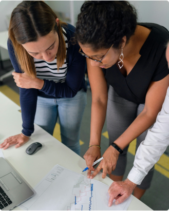Two girls looking at a piece of paper.