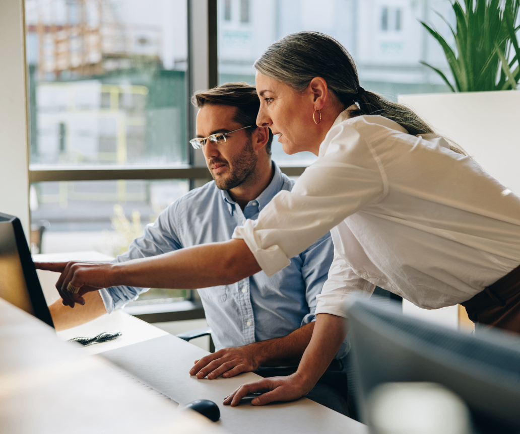 IT support team looking at salary guide on computer
