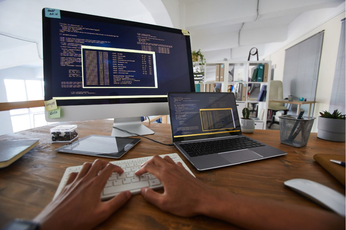 2 computer screens showing a developer coding