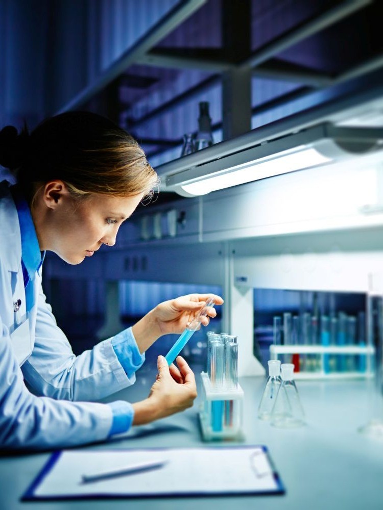 Biostatistician looking at test tube
