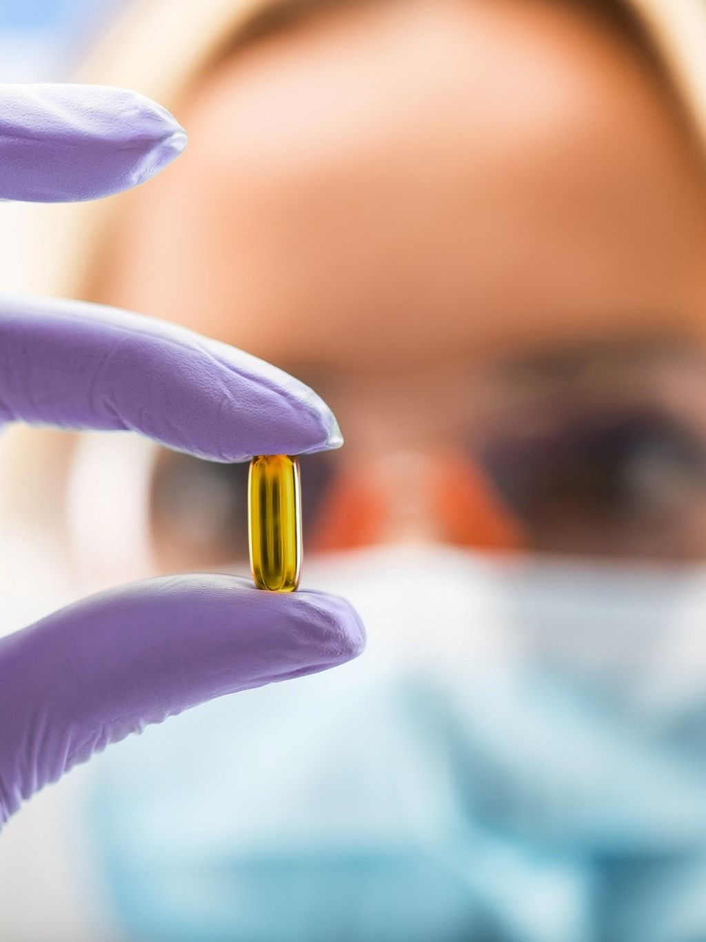 woman holding pill