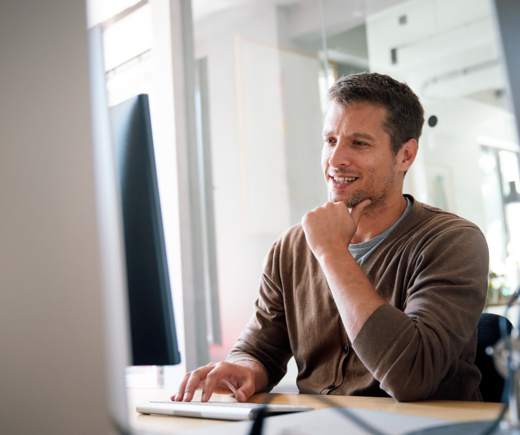 Senior DevOps manager looking at salary guide on computer