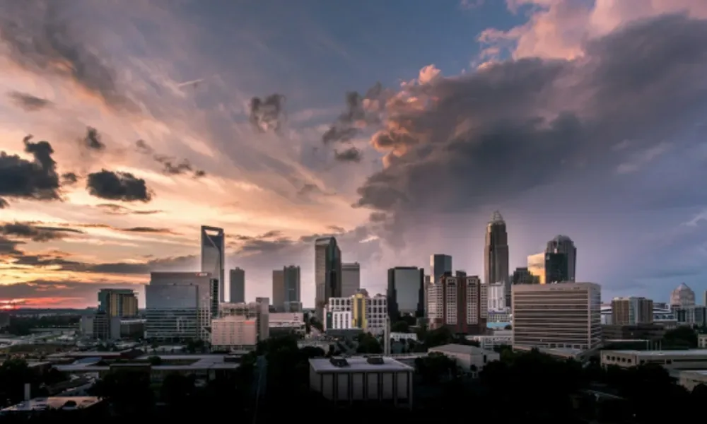 alt=Greensboro skyline with sunset