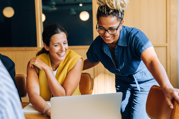Hiring managers looking at salary guides on laptop