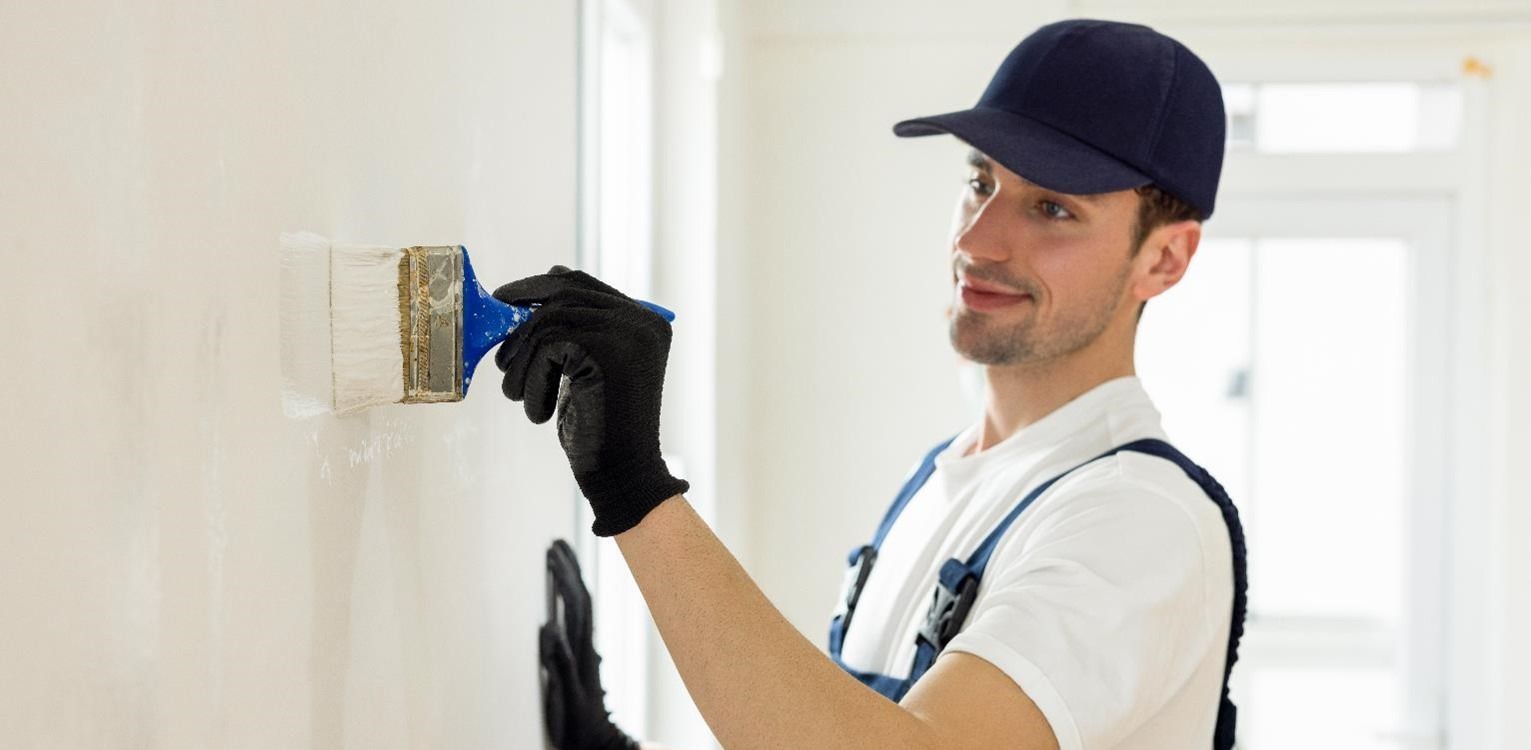 Handyman painting a wall