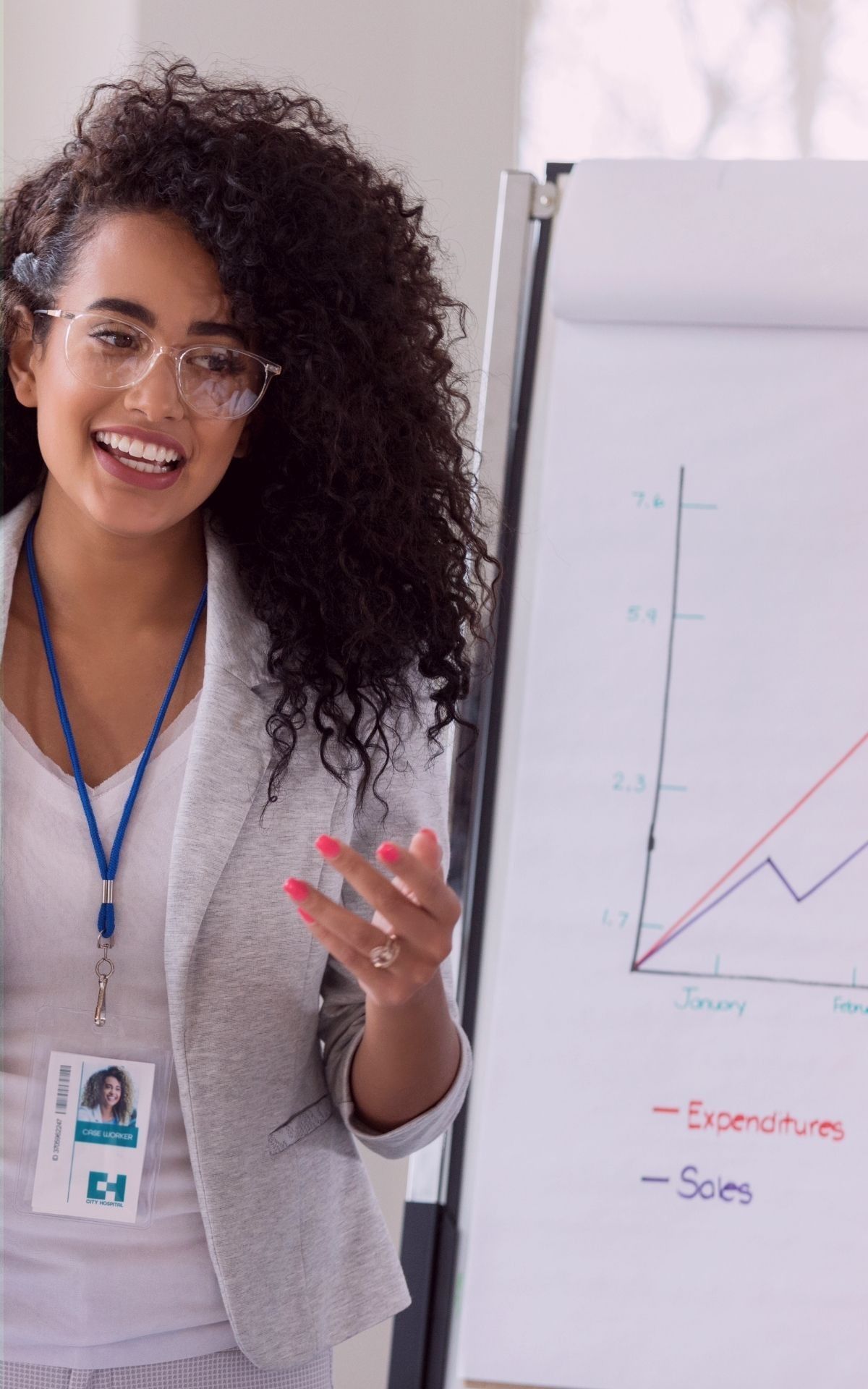 Female professional standing in front of a graph on a whiteboard