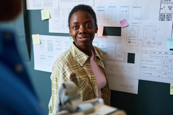 UX designer discussing 2026 salary data with team member