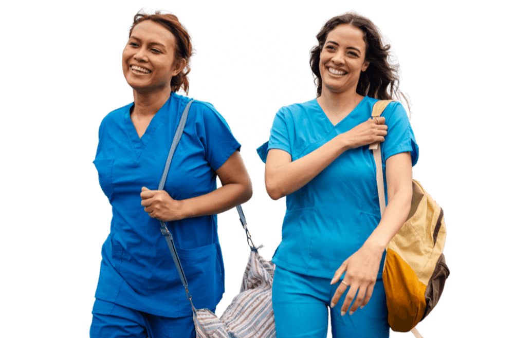 Two healthcare professionals in blue scrubs carrying bags