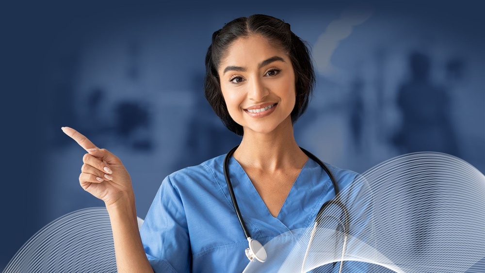 Smiling healthcare professional in blue scrubs pointing left, showing how to submit your CV to Global Medics 