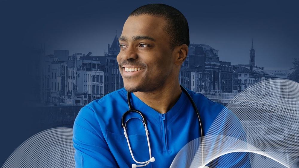 Smiling medical professional in blue scrubs with stethoscope, standing in front of River Liffey. Representing international healthcare careers opportunities at Global Medics 