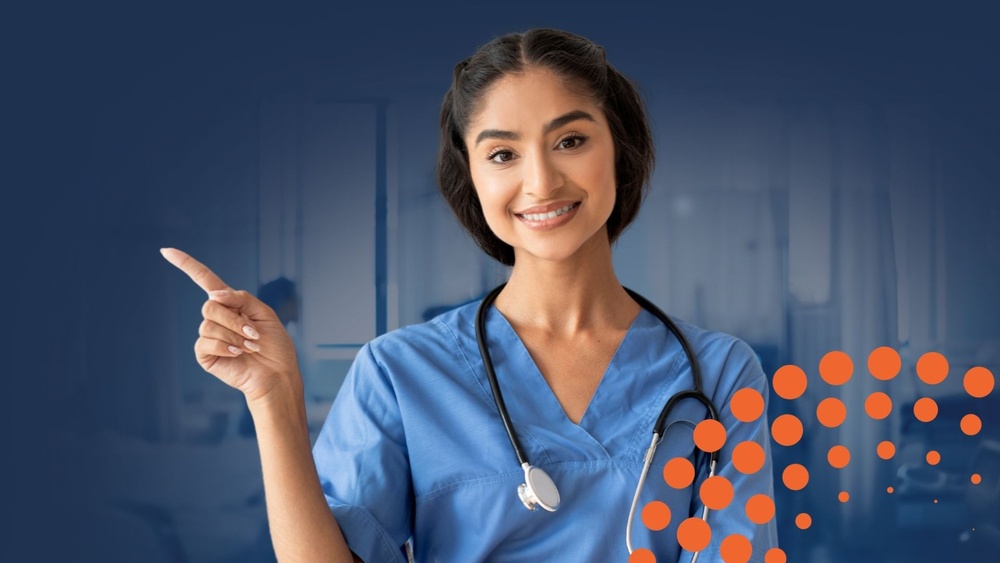 Smiling healthcare professional in blue scrubs pointing left, showing how to submit your CV to Global Medics 