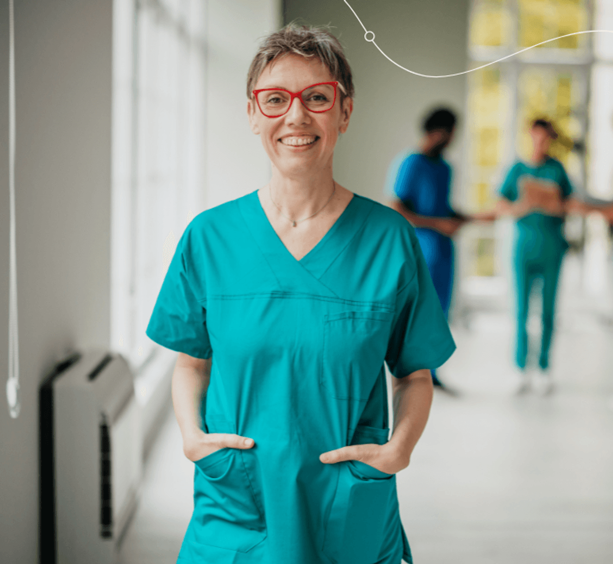 Healthcare professional in scrubs standing in a clinical setting