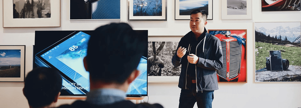 Man talking in front of a crowd.