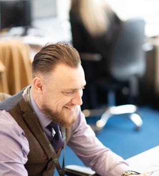 smiling man at a desk