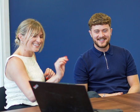 group of office workers sat round a table