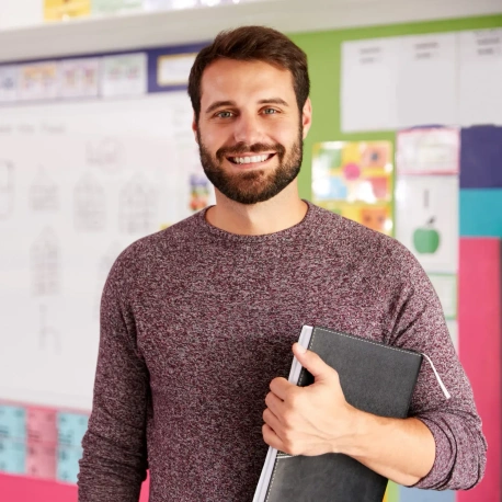 Male teacher holding a notebook.