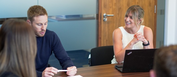 office workers round a table