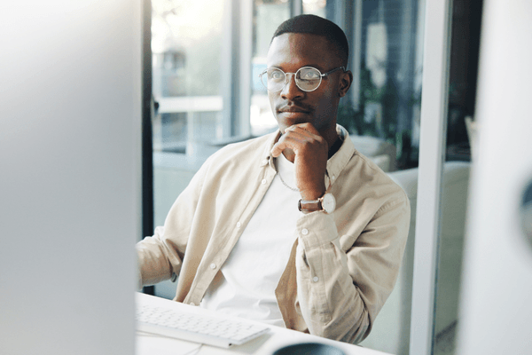 Creative professional looking at 2026 salary data on desktop