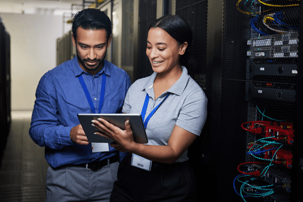 IT networking team looking at 2026 salary data on tablet