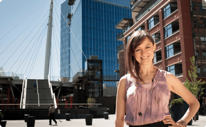 Smiling job seeker standing in a downtown Denver plaza