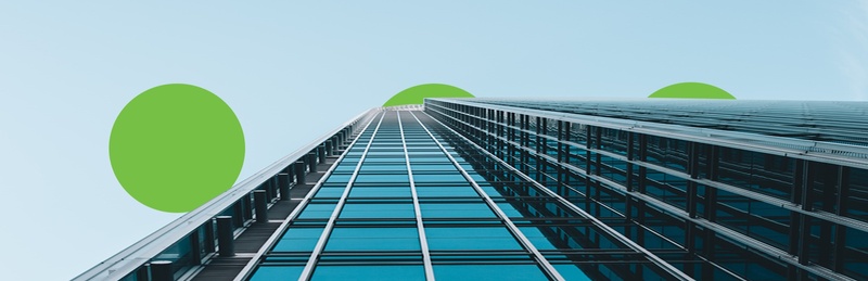 A building with a unique design, showcasing green circles across its surface.