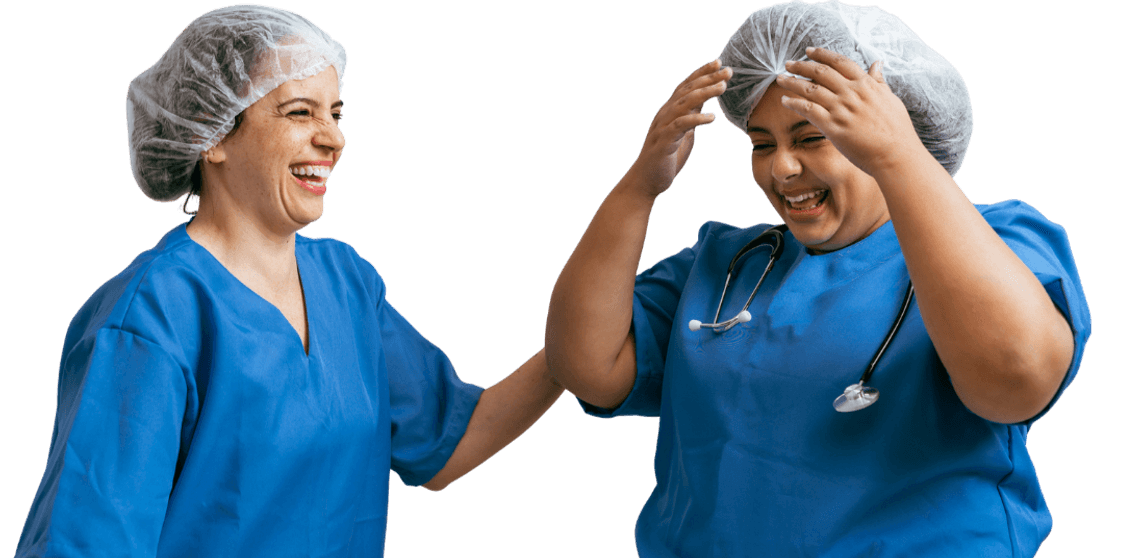 Two healthcare professionals in blue scrubs and disposable caps, one adjusting a cap and the other offering support, representing nurse and midwife referral opportunities with Medacs Healthcare.