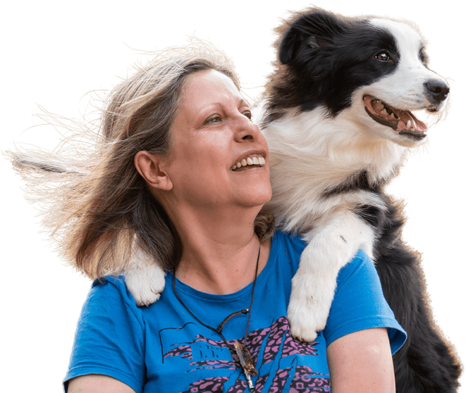 Person holding a dog in a close, affectionate moment, symbolising companionship, wellbeing and emotional support.