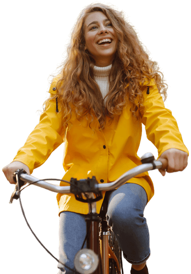 Smiling doctor riding a bike in yellow rain jacket, symbolising Medacs Healthcare’s commitment to wellbeing and lifestyle-friendly careers.