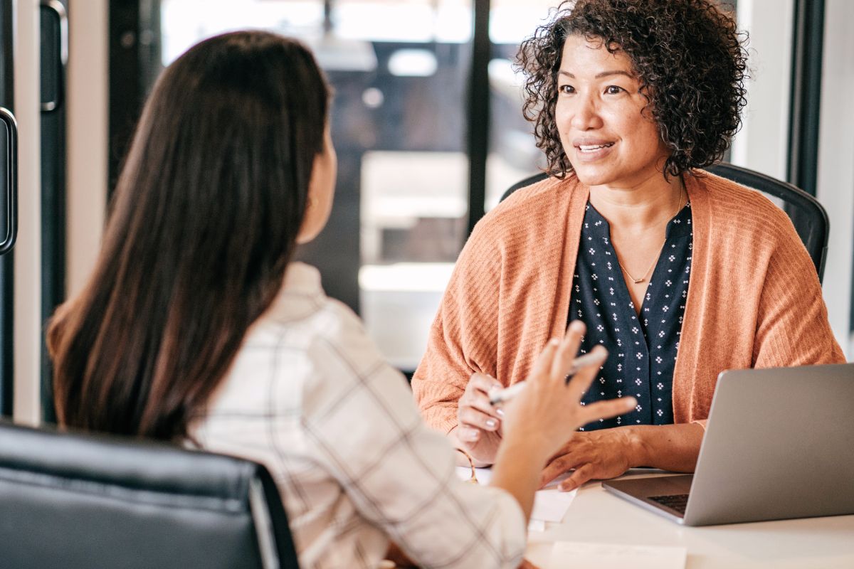two women professionals in an interview setting