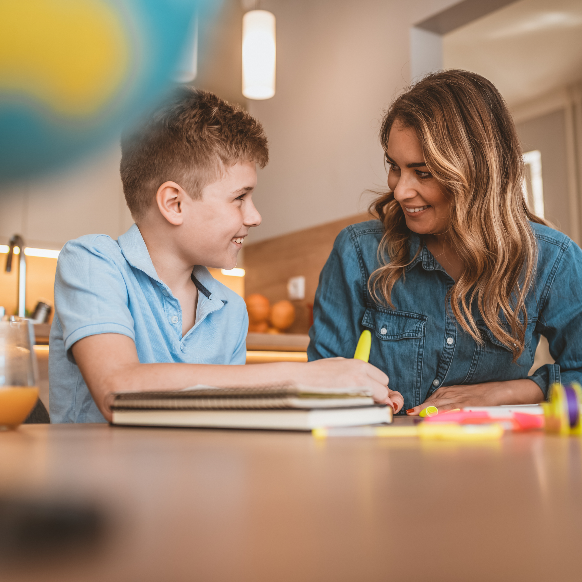 A teaching assistant helping a primary age pupil 