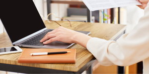A manager looking over vetting documents for social care compliance