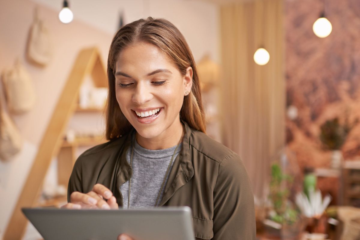 Professional looking at tablet working on personal branding for their job search strategy in August