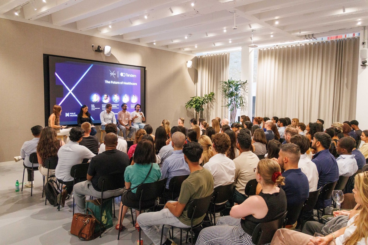Attendees listen to a panel discussion at NXGN's The Future of Healthcare event in London. Industry leaders share insights on the future of AI in healthcare, digital innovation, and clinical adoption during a live discussion with an audience of healthcare and technology professionals.